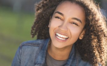 Stock image of a young girl smiling outside